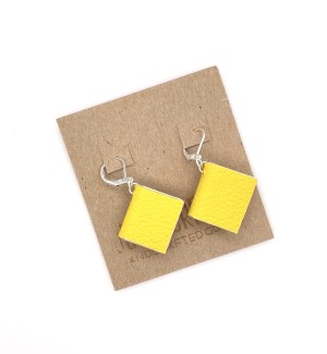 A pair of earrings with small, functional yellow colored books.