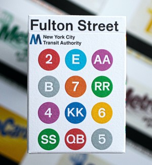 the front of a pack of playing cards with 'Fulton Street' and twelve circles of color on the cover of the box.
