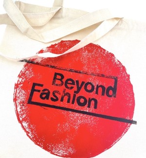 Beyond Fasion logo printed on red circle on a tote bag.