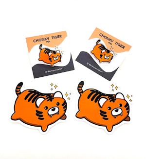 two pins in the shape of a cartoonish tiger and two matching stickers.