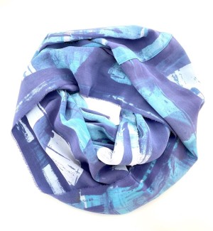 a silk scarf with patches of dusty purple, light blue and white arranged in a donut shape.