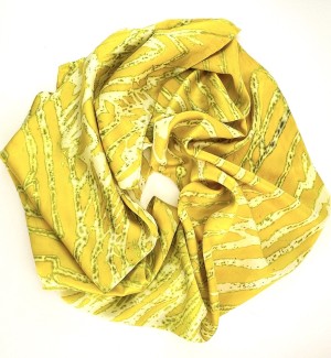 a silk scarf with a straitions of colors including chartreuse yellow and white.
