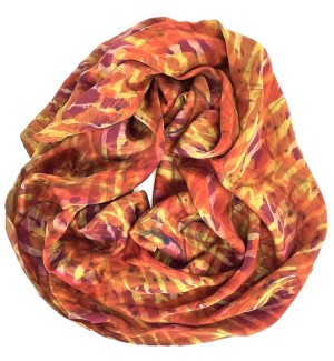 a silk scarf arranged in a circle with swirls of color - orange, gold and pink.