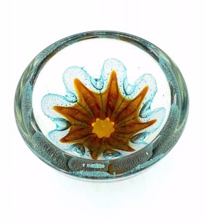 a round clear glass bowl with a starfish like gold design in the center with air bubbles around it. 