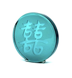 a round green glass disc with the Chinese character 'Double Joy, Double Happiness'. 
