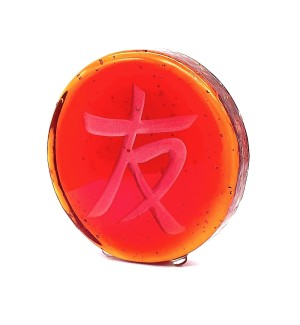 a red round glass disc with the Chinese character 'Friend, Friendship'. 