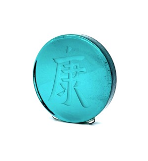a round green glass disk with a sand blasted Chinese character 'Good Health'. 