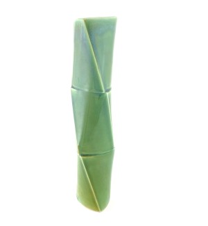 a tall narrow green ceramic vase in the shape of three bamboo sections. 