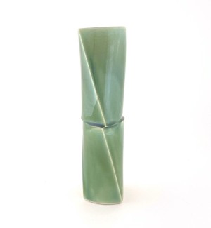 a tall narrow green ceramic vase in the shape of two bamboo sections.