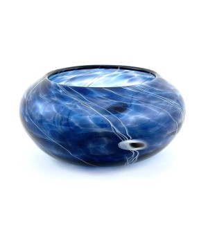 a translucent blue glass bowl with thin white lines that resemble star trails in a night sky.