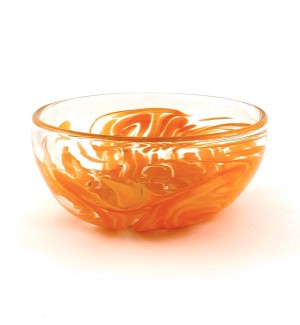a translucent clear glass bowl with swirls of bright orange.