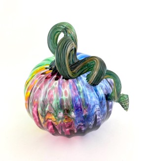 a translucent glass pumpkin with an array of color blends that resemble the rainbow.