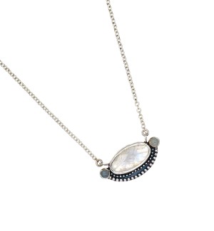 a pendant with a faceted moonstone is bezel set in Sterling. Accentuated with a series of Sterling beads and two bezel set aquamarine stones.