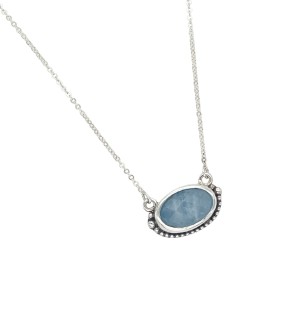 a pendant with a powder blue-hued, faceted aquamarine stone is bezel set in Sterling. Accentuated with a series of Sterling beads. 