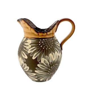 a ceramic vase with a dark clay body, brush stroke illustrations of sunflowers and an ochre glaze at the rim and handle.