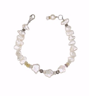 a bracelet of naturally formed white pearls and a silver clasp. 