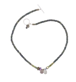 a necklace of strung mossy-hued polished round beads with small silver charms and a toggle clasp.