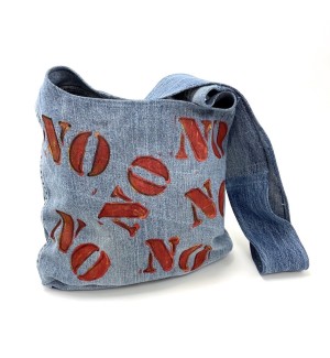 a handsewn shoulder bag of blue jean material with a painted illustration of stenciled letters 'Yes, No, Maybe'.