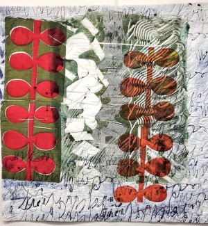 a painterly fabric quilt with a series of three cut panels each with a distinct pattern, a bright red vine form on green, a cluster of white block forms on textured grey, and an orange vine form on sage green.