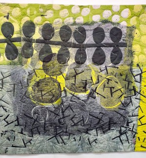 a painterly fabric quilt with a bold string of black leaf forms over a chartreuse and grey background.