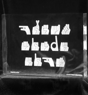 a clear acrylic block with 'great minds sign' in ASL.