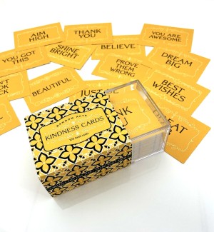 Yellow box with scroll pattern, note cards with positive affirmations written on them.