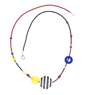 a mixed bead necklace with a red and blue strand embellished with larger blue, black and white accent beads strung in an asymetrical pattern 