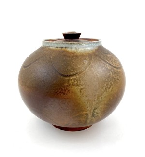 a round brown ceramic lidded pot.