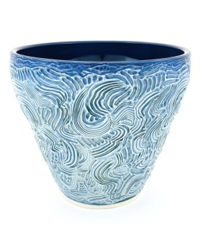 hand thrown ceramic bowl with a full textural combed surface in a light blue with a deep blue interior.