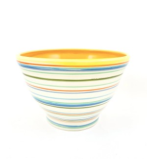 a hand thrown ceramic bowl decorated and glazed with multicolored lines with an egg yolk yellow interior. 