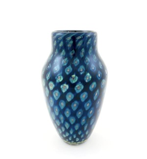 a handblown glass vase with a narrow opening, a shouldered top that narrows to the base with a deep blue and lighter blue cat-eye pattern.