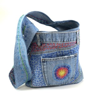 a blue jean fabric bag with hand embroidery.