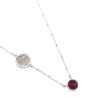 a sterling silver beaded chain necklace with a red faceted stone in a bezel setting accented with a silver filagree disk.