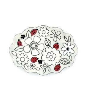 a ceramic trinket tray with a scalloped edge and an illustration of strawberries amongst white flowers.