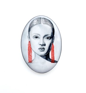 hand painted white ceramic brooch featuring a woman with red earrings. 