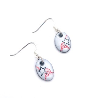a pair of white ceramic dangle earrings with an illustration of a star amongst the clouds.