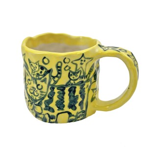 Brightly colored yellow mug with blue cats painted on