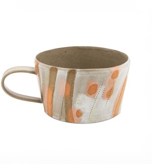 stoneware mug with luminous orange tones