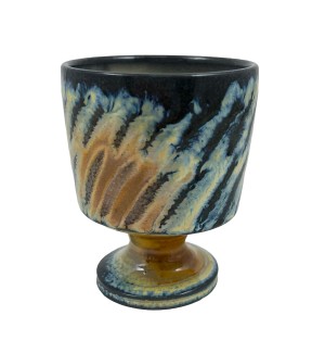 a hand-thrown stemware cup with bright blue and tan stripes