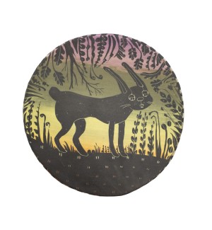 a circle sculpture plate with a sunset in the background and a bunny and plants in the foreground painted in black and details created by carving