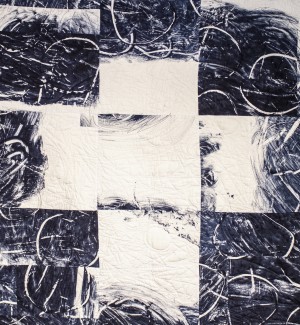 an abstract quilt with a dark blue and white palette