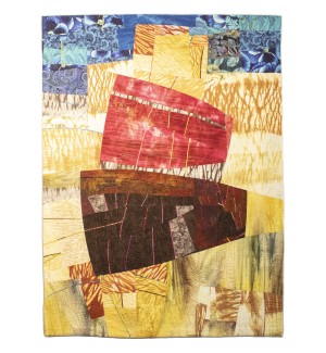 a quilt with shades of red, yellow, and blue