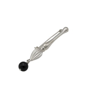 brooch that balances sculptural silverwork with a striking dark accent