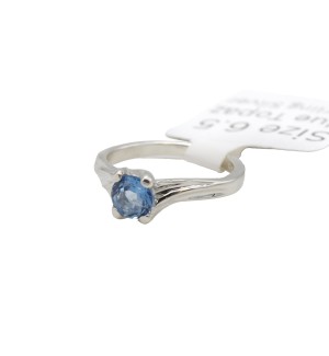 a sterling silver ring made with blue topaz and formal references to tree branches