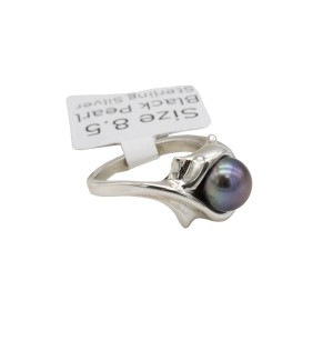 a sterling silver ring with a black pearl and formal references to cats