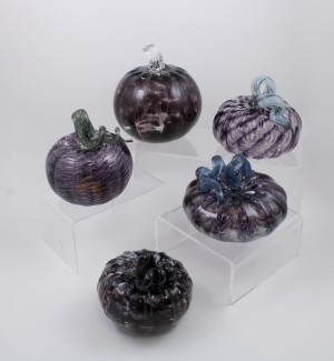 a variety of deep purple glass pumpkins