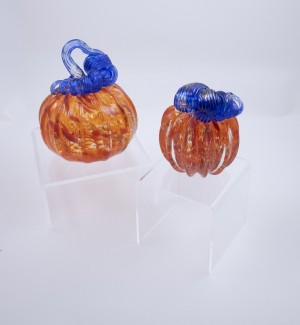 a duo of orange pumpkins with blue stems