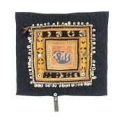 square fabric quilt with stylized human form in center surrounded by hand stitched decoration and a cockle shell border.