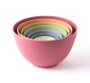 A set of 7 nested bowls in rainbow colors, the largest bowl is pink, orange, yellow, green, blue, purple, and the smallest is white.
