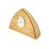 a small triangular wood clock with a birdseye maple veneer and round brass ringed clock face.